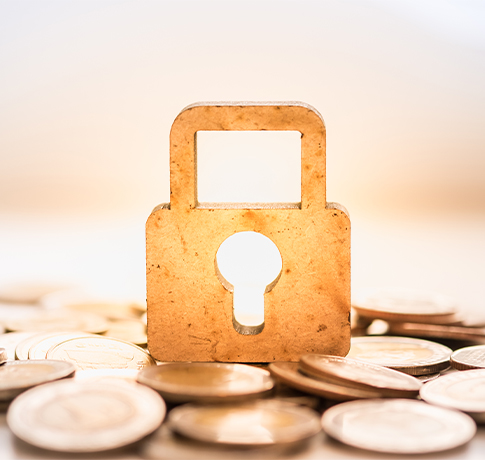 padlock on top of money keys to a successful retirement